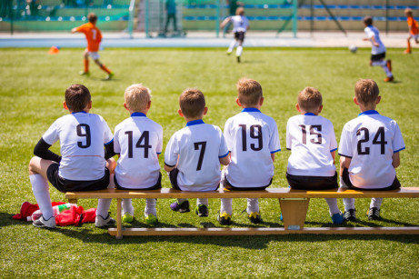 50564223 - football soccer match for children. kids waiting on a bench.